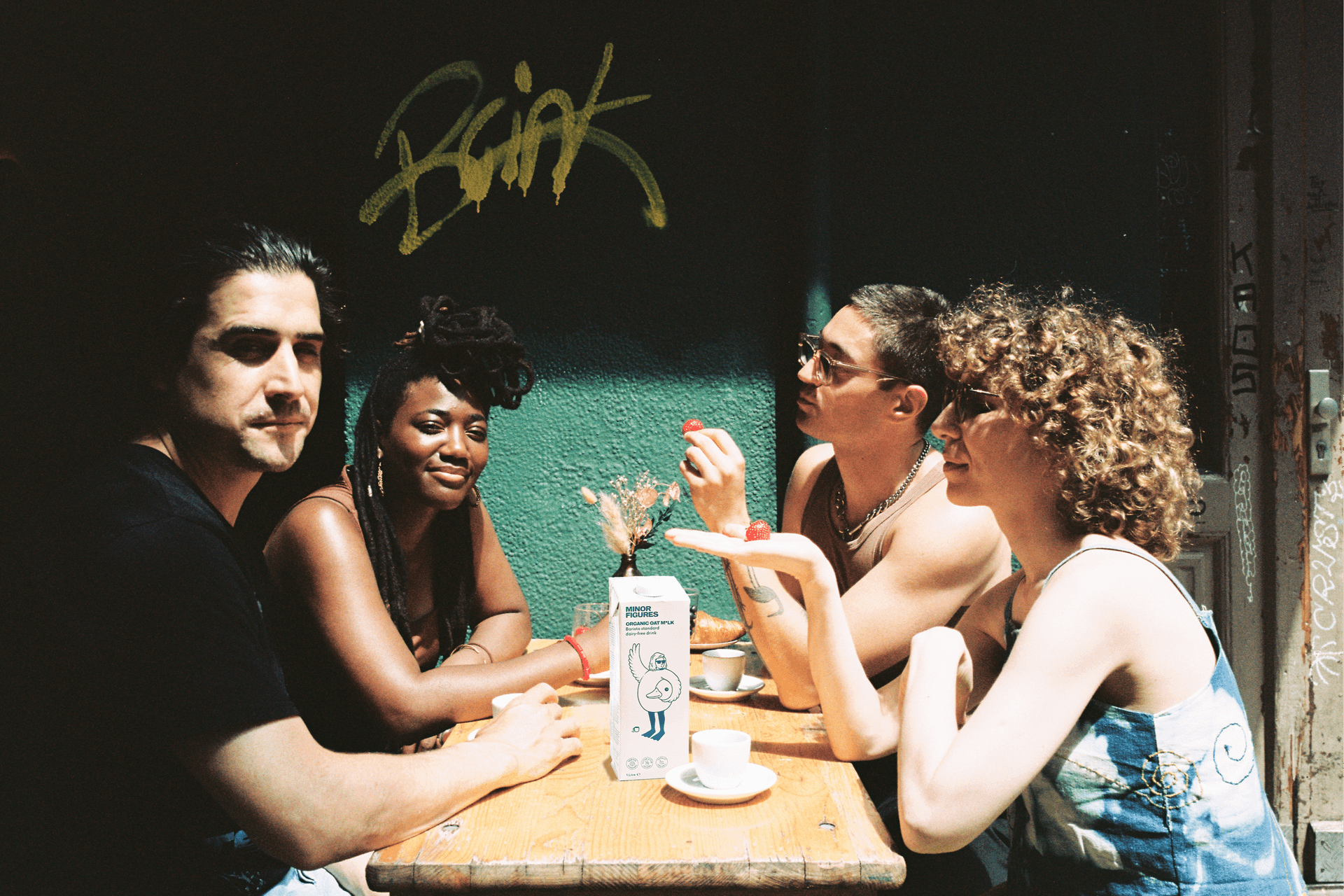 Breakfast show hosts Nordberg, Mokeyanju, Nikola and Nadia Wise sit around a table outside Oona bar drinking coffee